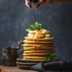 Drizzling honey over perfect pancakes